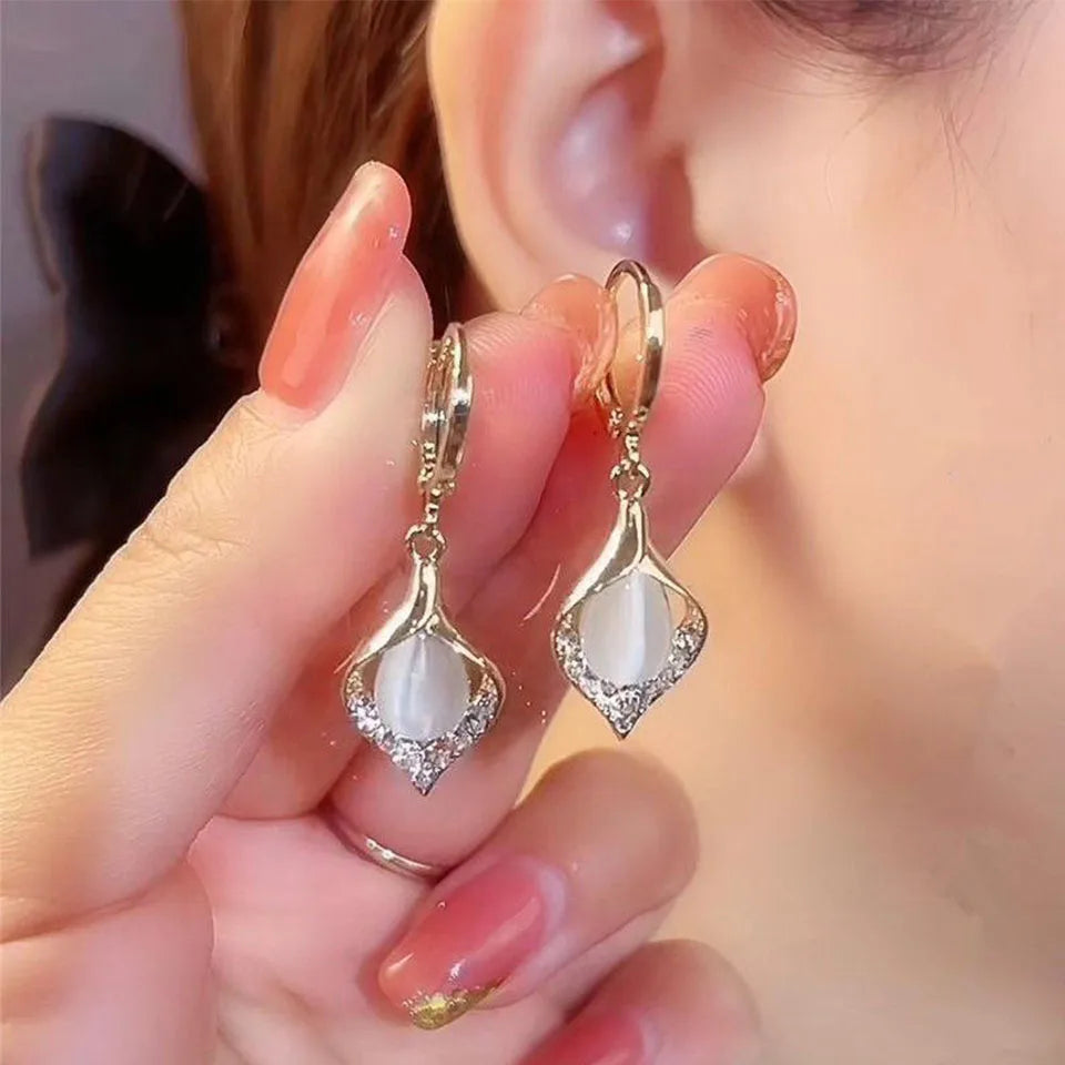 Woman wearing Angel Eye tulip petal hoop earrings – perfect party accessory