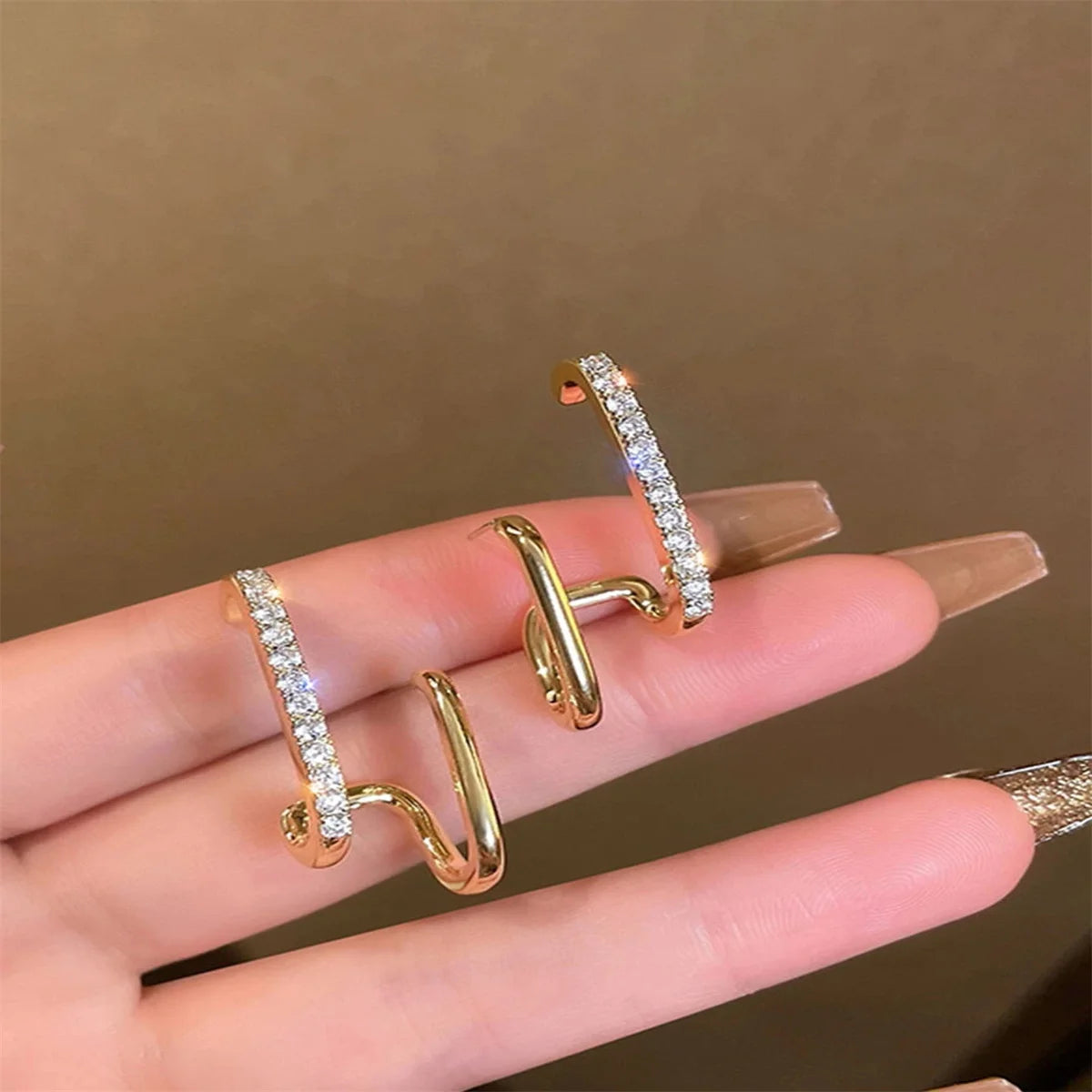 Detailed gold-color earrings with sparkling crystal accents